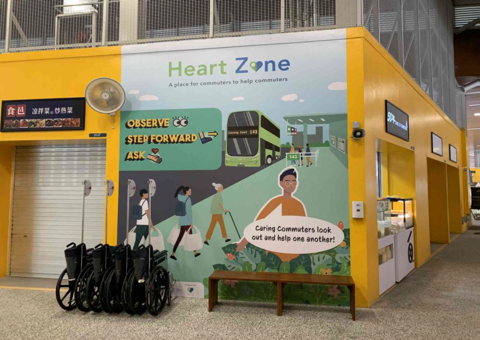 Add your alHeart Zone mural at Jurong East Bus Interchange showing commuters and volunteers posing with wheelchairs.t text here